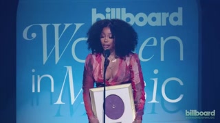 SZA Accepts the Award for Woman of the Year from Coi Leray 