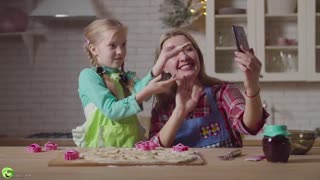 Family live streaming with phone during cooking